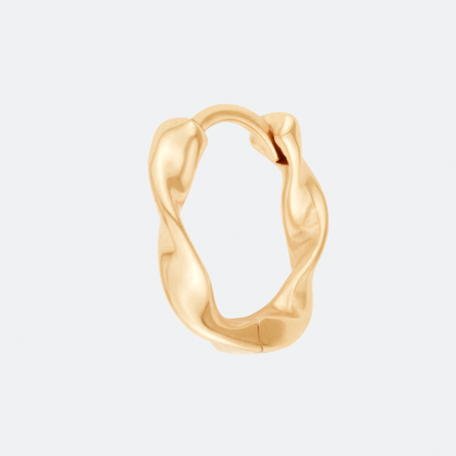 The Undae Mini hoop earring by Ocarina, an 18K gold-plated design with a fluid, organic shape inspired by natural waves. A minimalist yet bold statement piece, displayed against a clean white background